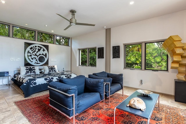 tiled bedroom with ceiling fan and multiple windows