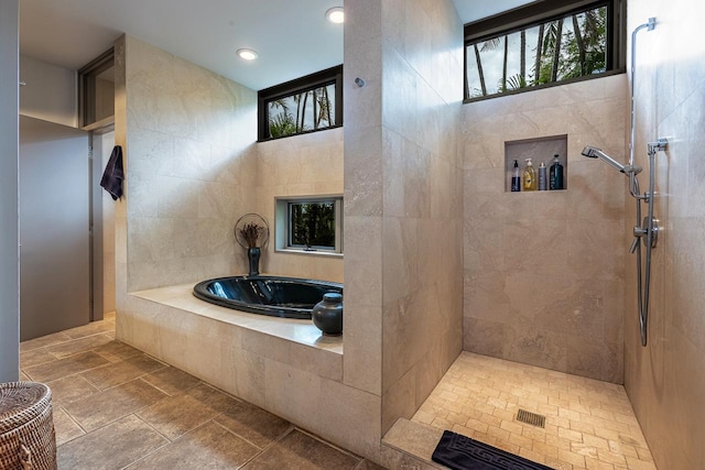 bathroom with tile patterned floors and plus walk in shower