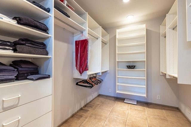 spacious closet featuring light tile patterned floors