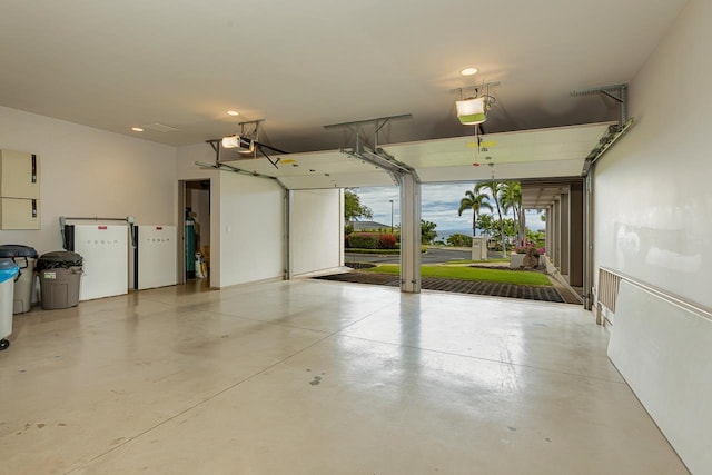 garage featuring a garage door opener and white fridge