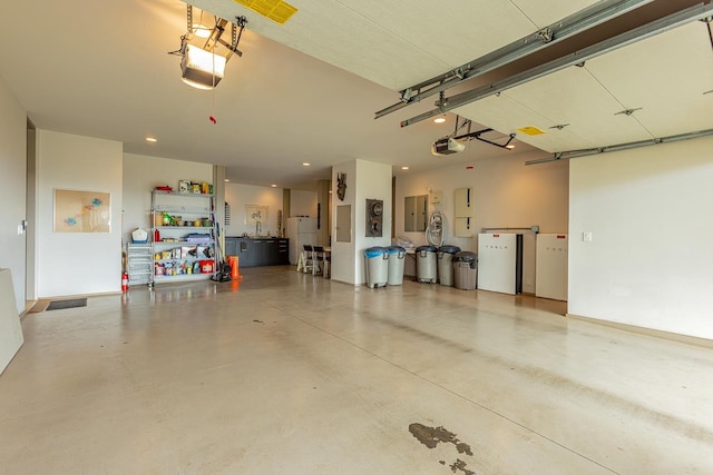 garage with electric panel and a garage door opener