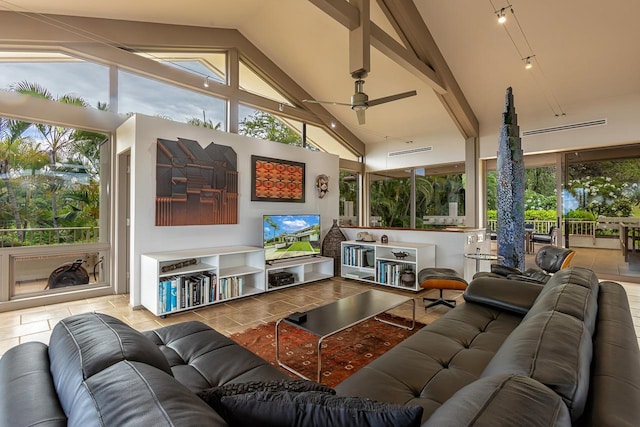 tiled living room with ceiling fan, high vaulted ceiling, and plenty of natural light