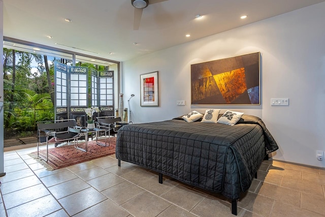 tiled bedroom with ceiling fan, access to exterior, and a wall of windows