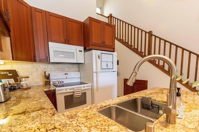 2737 S Kihei Rd Unit 311, Kihei, HI 96753 - kitchen featuring white appliances, a sink, backsplash, light stone counters, and brown cabinets