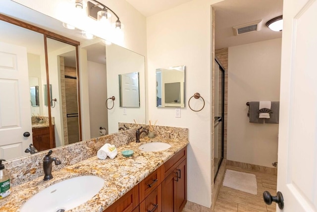 2737 S Kihei Rd Unit 311, Kihei, HI 96753 - bathroom with double vanity, a shower with shower door, and baseboards