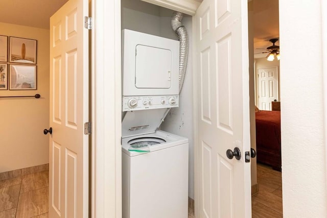 2737 S Kihei Rd Unit 311, Kihei, HI 96753 - laundry room with stacked washing machine and dryer, ceiling fan, and baseboards
