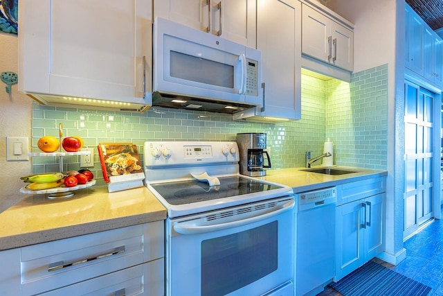 kitchen with tasteful backsplash, white appliances, white cabinetry, and sink