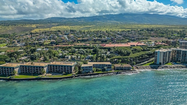 birds eye view of property with a water and mountain view