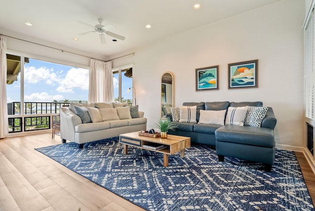 living room with hardwood / wood-style floors and ceiling fan