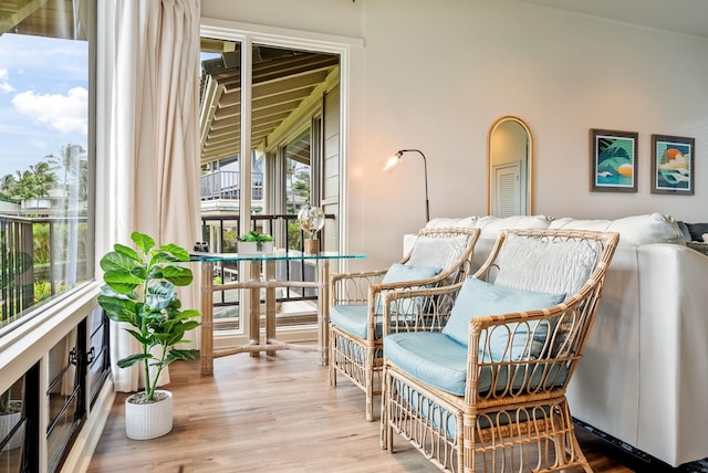 sitting room featuring lofted ceiling and light hardwood / wood-style flooring