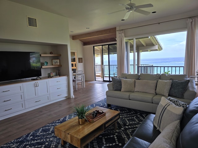 living room featuring ceiling fan, wood-type flooring, and a water view