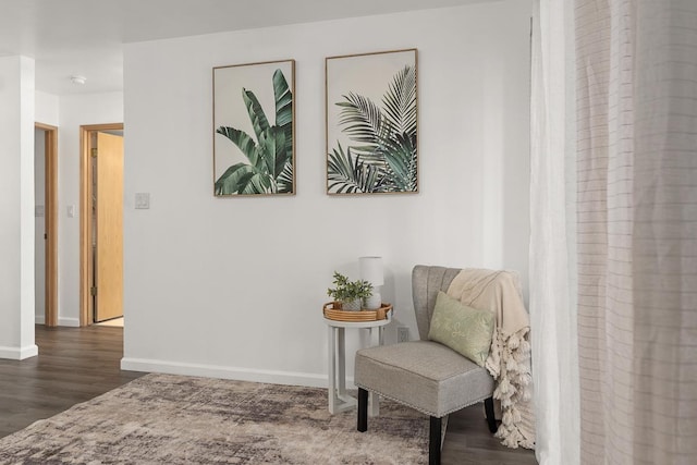 living area with wood finished floors and baseboards