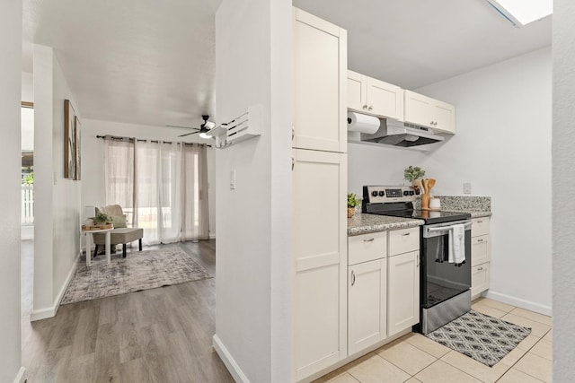 kitchen featuring stainless steel range with electric cooktop, under cabinet range hood, white cabinetry, ceiling fan, and baseboards