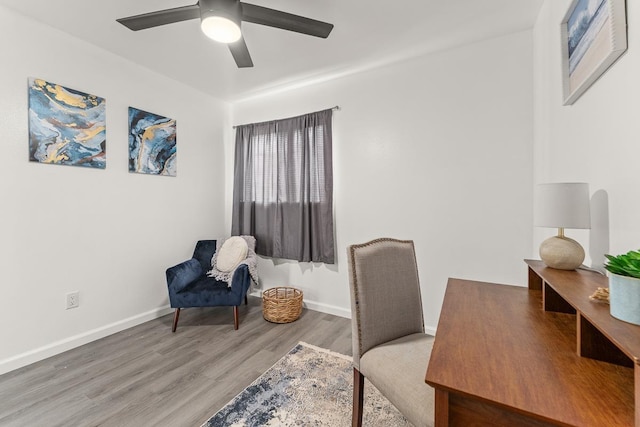 home office featuring wood finished floors, a ceiling fan, and baseboards