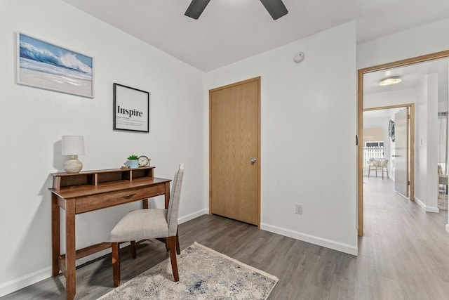 office area featuring wood finished floors, a ceiling fan, and baseboards