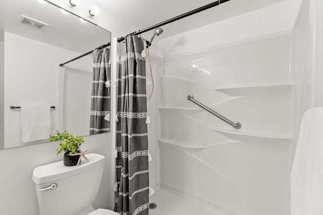 full bath with a shower stall and toilet