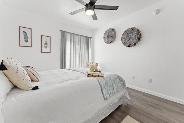bedroom featuring wood finished floors, baseboards, and ceiling fan