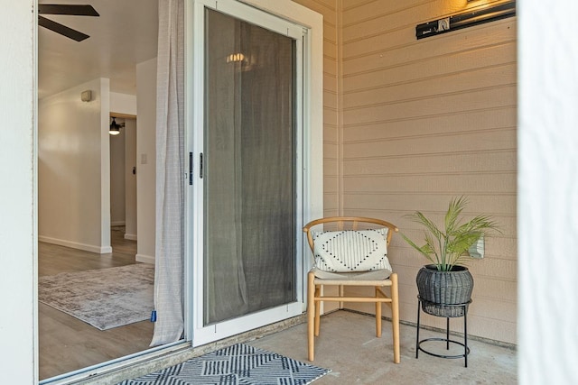 doorway to property featuring ceiling fan