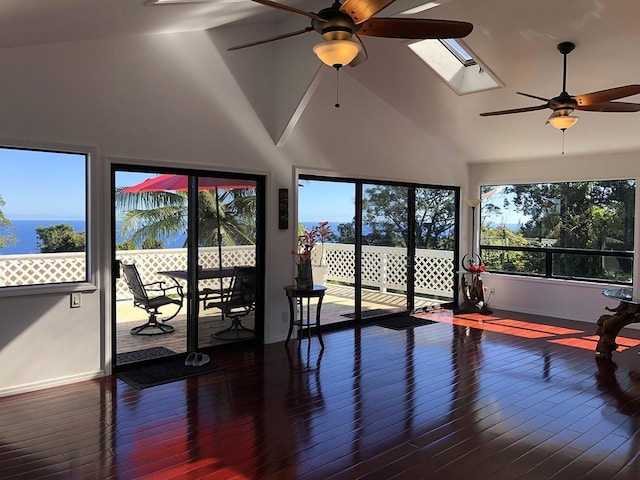 sunroom / solarium with ceiling fan and lofted ceiling with skylight