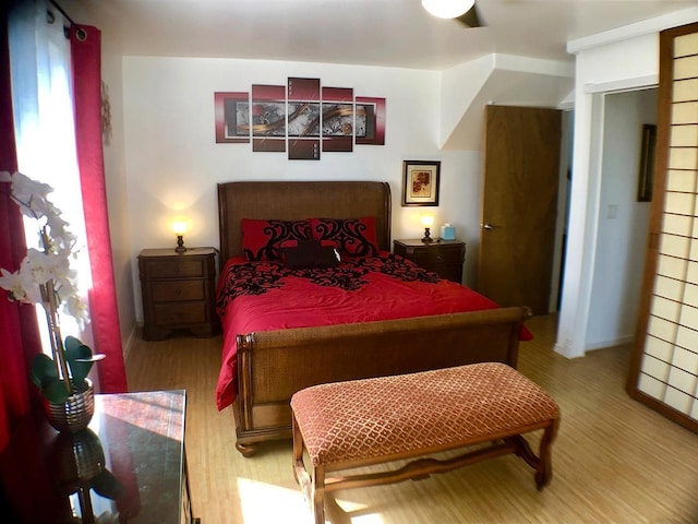 bedroom with hardwood / wood-style flooring and ceiling fan