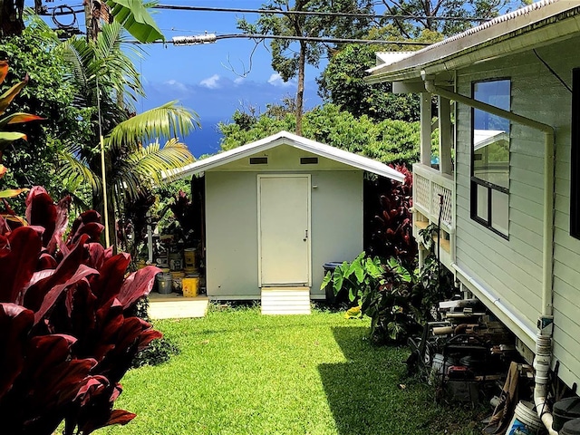 view of outbuilding featuring a lawn