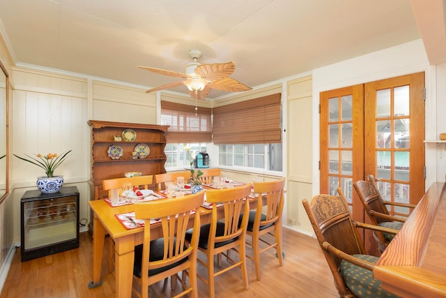 dining area featuring a ceiling fan, crown molding, and light wood-style flooring