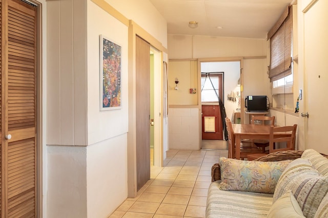 hall featuring light tile patterned floors