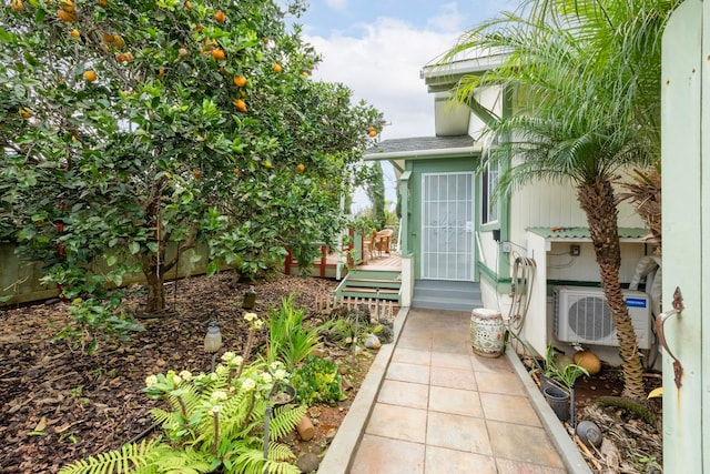 view of exterior entry featuring a deck and ac unit