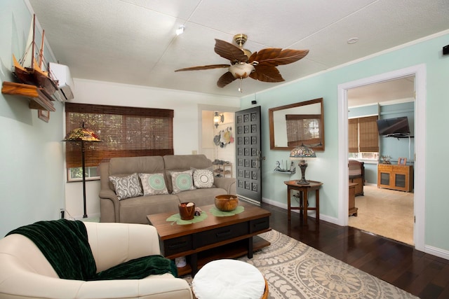 living room featuring ceiling fan, dark wood-type flooring, baseboards, ornamental molding, and a wall mounted air conditioner
