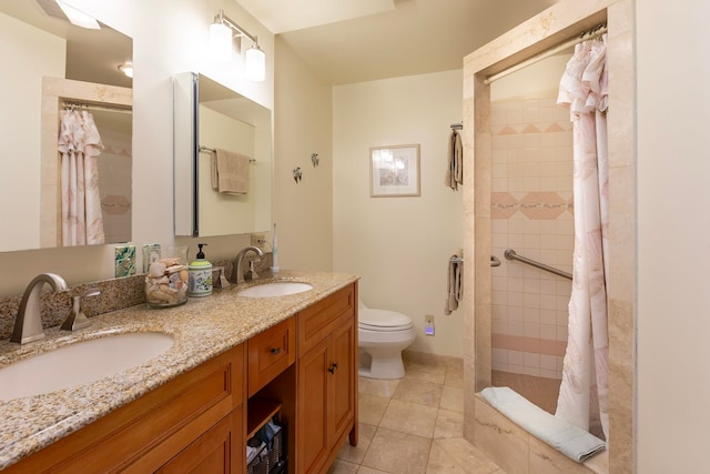 bathroom featuring double vanity, a sink, toilet, and baseboards