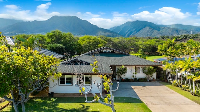 exterior space featuring a mountain view and a front yard