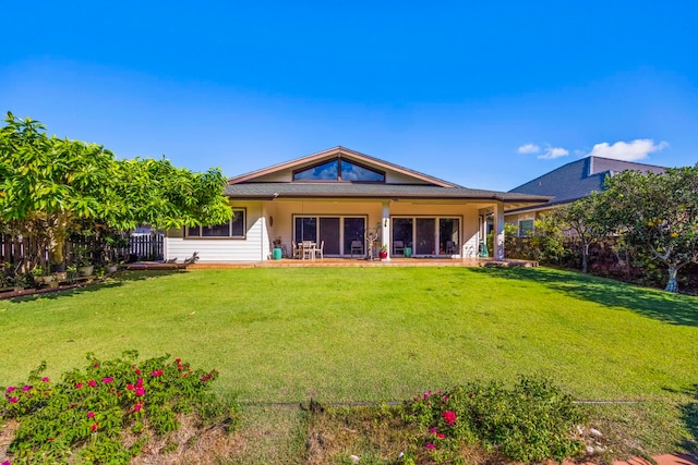 rear view of property featuring a yard