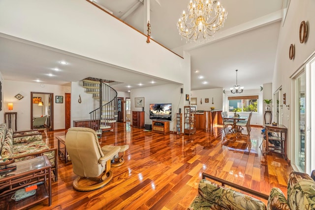 living room with hardwood / wood-style flooring, a notable chandelier, beamed ceiling, and high vaulted ceiling