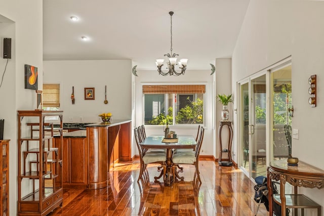 dining room featuring hardwood / wood-style flooring and an inviting chandelier