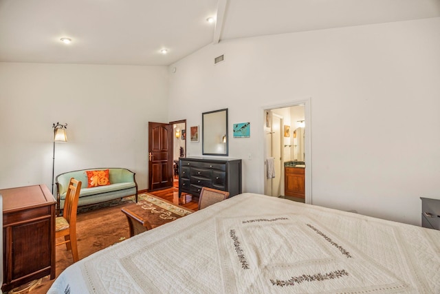 bedroom featuring hardwood / wood-style flooring, high vaulted ceiling, and ensuite bathroom