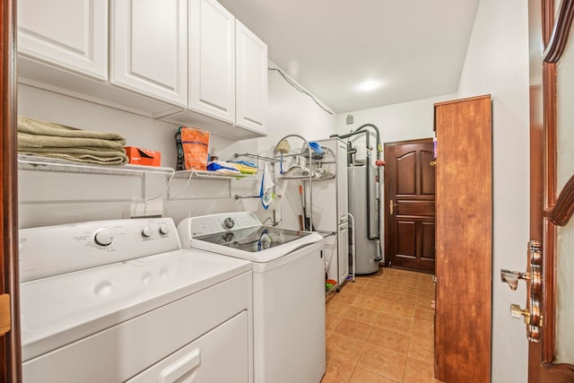 laundry area featuring light tile patterned floors, cabinets, gas water heater, and independent washer and dryer