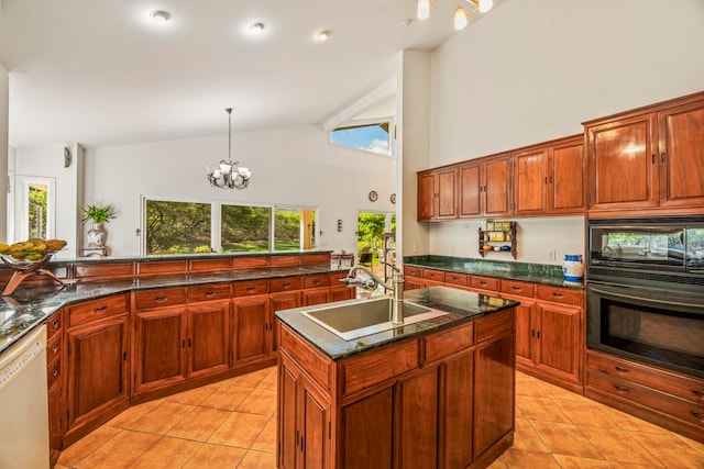 kitchen with sink, pendant lighting, a chandelier, a center island with sink, and black appliances