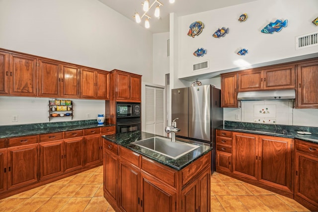 kitchen featuring a center island, high vaulted ceiling, black appliances, sink, and light tile patterned flooring