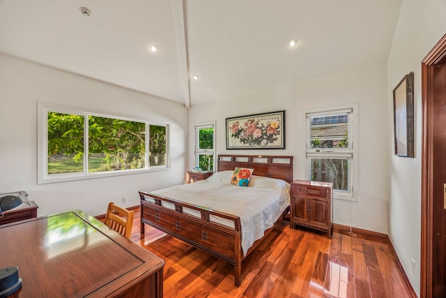 bedroom with wood-type flooring and vaulted ceiling