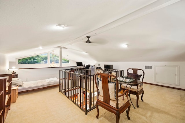 interior space with lofted ceiling with beams, light colored carpet, and ceiling fan