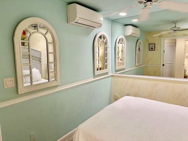 bedroom with a wall mounted AC and ceiling fan