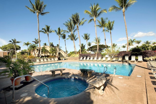 view of pool with a hot tub