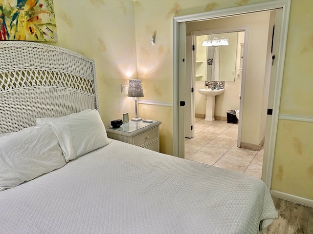 tiled bedroom with sink and connected bathroom