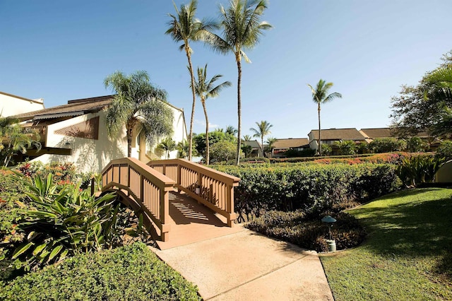 view of community featuring a yard and a deck