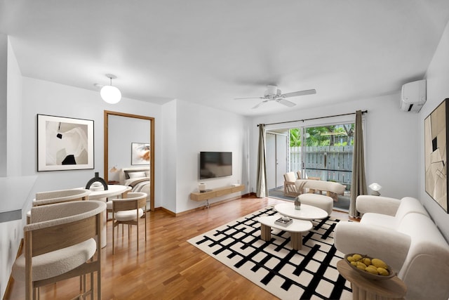36 Kunihi Ln Unit 213, Kahului, HI 96732 - living room featuring baseboards, light wood-type flooring, a wall unit AC, and a ceiling fan