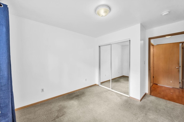36 Kunihi Ln Unit 213, Kahului, HI 96732 - unfurnished bedroom featuring baseboards, a closet, and carpet