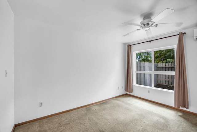 36 Kunihi Ln Unit 213, Kahului, HI 96732 - carpeted spare room featuring baseboards, a ceiling fan, and an AC wall unit