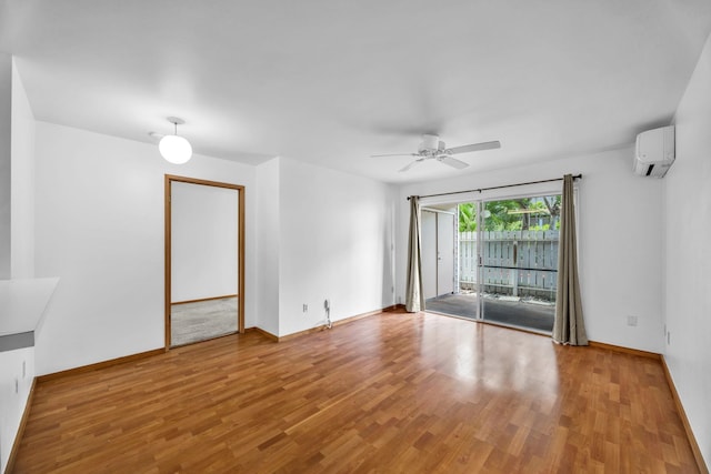 36 Kunihi Ln Unit 213, Kahului, HI 96732 - spare room with a wall mounted air conditioner, wood finished floors, a ceiling fan, and baseboards