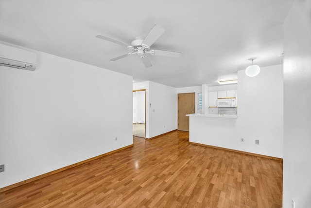 36 Kunihi Ln Unit 213, Kahului, HI 96732 - unfurnished living room with ceiling fan, baseboards, a wall mounted AC, and light wood-style floors