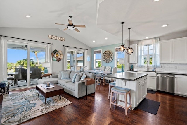 living area featuring recessed lighting, vaulted ceiling, dark wood finished floors, and ceiling fan with notable chandelier